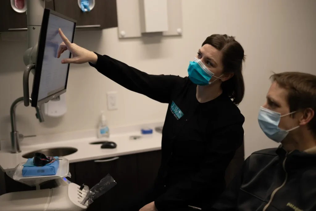 Lewis Family & Implant Dentistry dentist going over a dental scan with a patient