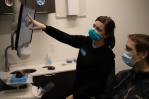 Lewis Family & Implant Dentistry dentist going over a dental scan with a patient