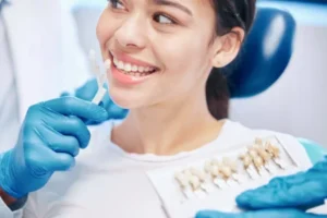 A Vancouver WA resident smiling while their dentist matches their teeth shade for their new crown